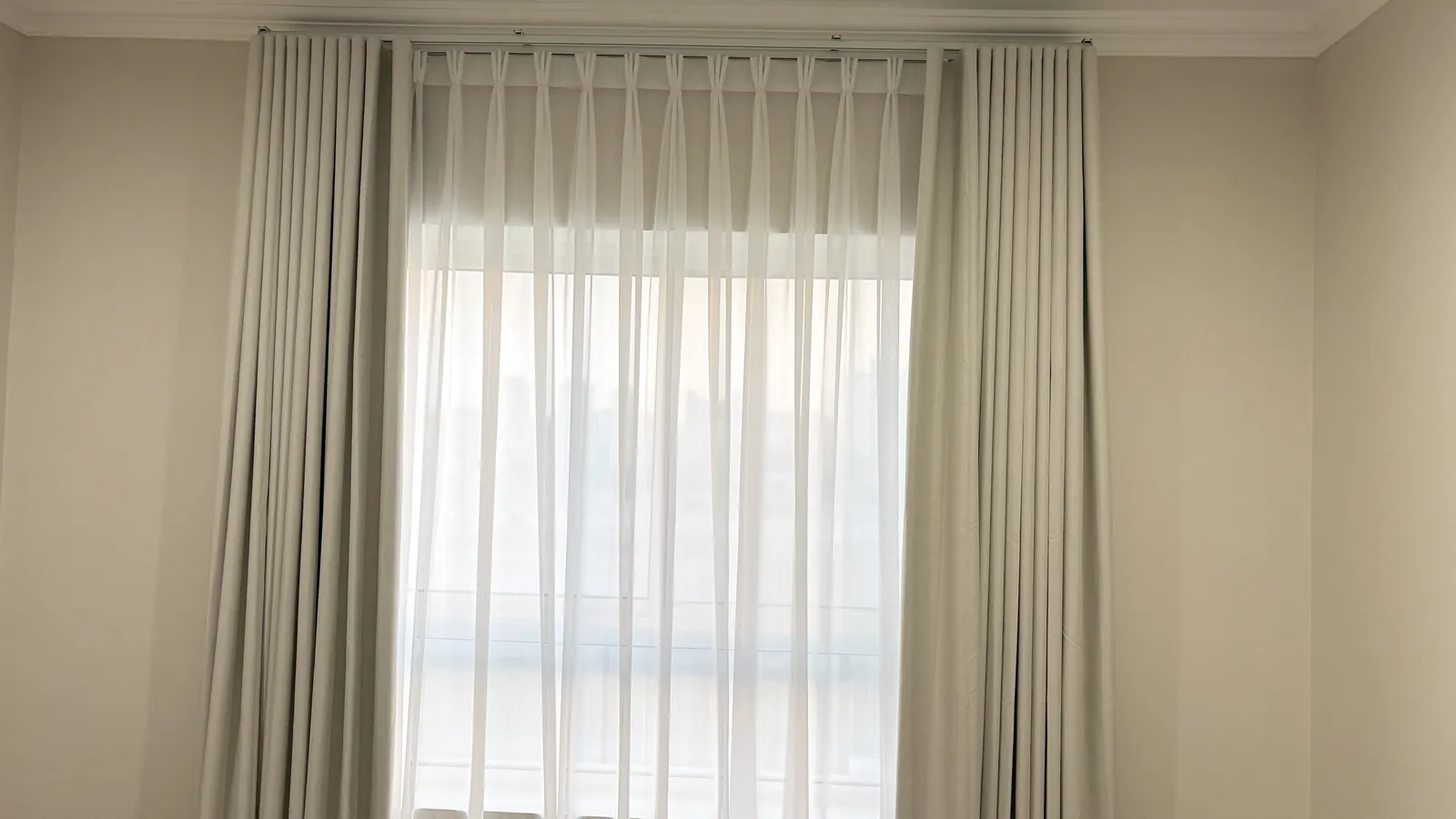 Wave curtains and a sheer on a window in Doha
